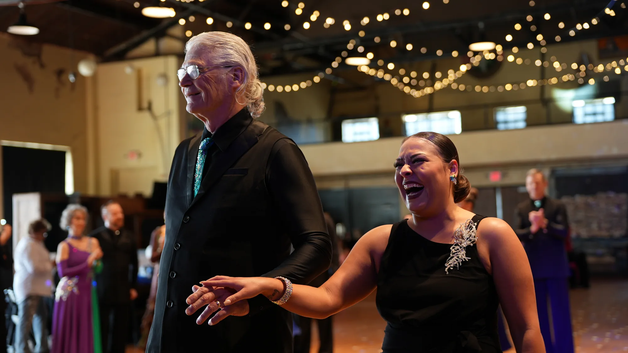 A pro-am couple receiving their awards at OK Dancesport